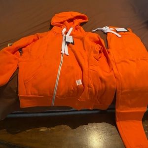 Orange very comfortable jogging suit never worn it’s Brand New